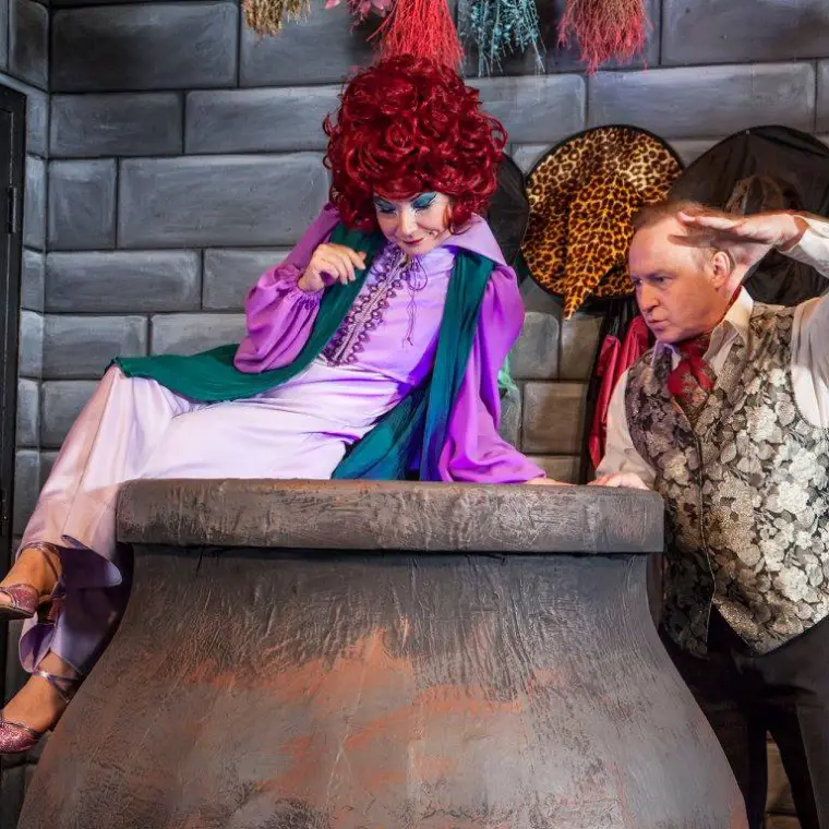 a person standing in front of a building talking on a cell phone